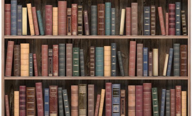 Vintage books on old wooden shelf isolated on white. Old library or antique bookshop.